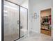 A modern shower boasts marble walls, glass doors, and a built-in bench in a bright bathroom at 413 Eagleview Dr, Moncks Corner, SC 29461