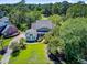Beautiful aerial view of a home with lush landscaping, mature trees, and a well-manicured lawn at 4227 Sawgrass Dr, North Charleston, SC 29420