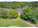 Aerial view of a home surrounded by mature trees and overlooking a golf course at 4227 Sawgrass Dr, North Charleston, SC 29420