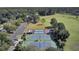Aerial view showcases community tennis courts, pickleball, basketball, and parking lot surrounded by trees at 4227 Sawgrass Dr, North Charleston, SC 29420