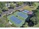 Aerial view features tennis and recreational courts, and a pool surrounded by lush greenery at 4227 Sawgrass Dr, North Charleston, SC 29420