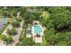 Aerial view of the sparkling community pool, cabanas, tennis courts, and parking area at Coosaw Creek at 4227 Sawgrass Dr, North Charleston, SC 29420