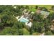 Aerial view of the community pool, tennis courts, lounge area, and pond surrounded by lush trees at 4227 Sawgrass Dr, North Charleston, SC 29420