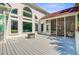A spacious back deck featuring a fire pit, large windows, and a screened-in porch for outdoor enjoyment at 4227 Sawgrass Dr, North Charleston, SC 29420