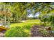 Beautiful view of the professionally landscaped backyard leading out to the golf course at 4227 Sawgrass Dr, North Charleston, SC 29420