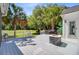 Backyard with a deck, outdoor kitchen, and palm trees overlooking the golf course at 4227 Sawgrass Dr, North Charleston, SC 29420