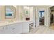 A bathroom vanity features white cabinetry, quartz countertops, and modern fixtures, with access to the bedroom and walk-in closet at 4227 Sawgrass Dr, North Charleston, SC 29420
