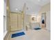 This spacious bathroom features a shower with glass doors and a vanity with good lighting at 4227 Sawgrass Dr, North Charleston, SC 29420