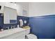 Charming powder room featuring blue wainscoting and vanity with sink and marble countertop at 4227 Sawgrass Dr, North Charleston, SC 29420