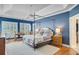 Primary bedroom features a tray ceiling, hardwood floors, and ample natural light from the windows at 4227 Sawgrass Dr, North Charleston, SC 29420