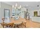Bright breakfast nook offering hardwood floors, a modern light fixture, and a view into the living room at 4227 Sawgrass Dr, North Charleston, SC 29420