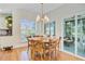 Bright breakfast nook with a round table, wood chairs, and sliding doors out to the screened in porch at 4227 Sawgrass Dr, North Charleston, SC 29420