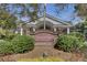 Charming entrance to the Coosaw Creek Clubhouse with brick accents and lush landscaping at 4227 Sawgrass Dr, North Charleston, SC 29420