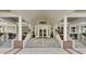 Elegant clubhouse entrance with brick and concrete stairs, decorative wreaths on doors and 'Crooked Creek' sign at 4227 Sawgrass Dr, North Charleston, SC 29420