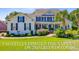 Charming two-story home with a manicured lawn and mature palm trees at 4227 Sawgrass Dr, North Charleston, SC 29420