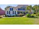 Well-maintained home featuring blue shutters, mature palms, and lush green lawn at 4227 Sawgrass Dr, North Charleston, SC 29420