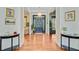 Elegant foyer with hardwood floors, console tables, and a welcoming front door at 4227 Sawgrass Dr, North Charleston, SC 29420