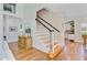 Bright and airy foyer with hardwood floors and staircase, flowing into the living room at 4227 Sawgrass Dr, North Charleston, SC 29420