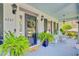 Charming front porch with rocking chairs, potted plants, and a welcoming front door with wreath at 4227 Sawgrass Dr, North Charleston, SC 29420