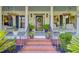 Welcoming front porch with hanging flowers and comfortable seating area at 4227 Sawgrass Dr, North Charleston, SC 29420