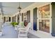 Inviting front porch with rocking chairs, hanging lantern, and light blue painted ceiling at 4227 Sawgrass Dr, North Charleston, SC 29420