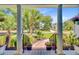 Beautifully landscaped front yard with palm trees and inviting entrance framed by white columns at 4227 Sawgrass Dr, North Charleston, SC 29420