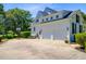 Spacious three-car garage with basketball hoop and lush landscaping at 4227 Sawgrass Dr, North Charleston, SC 29420