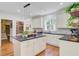 Bright kitchen features white cabinets, a center island with dark countertops, and stainless steel appliances at 4227 Sawgrass Dr, North Charleston, SC 29420