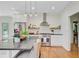 Open kitchen with stainless steel appliances, stone countertops, hardwood floors, and a view to the backyard at 4227 Sawgrass Dr, North Charleston, SC 29420