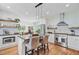 Bright open kitchen featuring stainless appliances, an island, and a view into the dining area at 4227 Sawgrass Dr, North Charleston, SC 29420