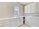 Bright laundry room with modern appliances, plenty of cabinet space, and a convenient sink area at 4227 Sawgrass Dr, North Charleston, SC 29420