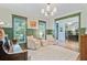 Well appointed living room with piano, soft chairs and natural light at 4227 Sawgrass Dr, North Charleston, SC 29420