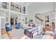 Open-concept living room offers hardwood floors, a fireplace, an upper balcony, and plenty of natural light at 4227 Sawgrass Dr, North Charleston, SC 29420