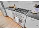Close up shot of the large stainless steel gas oven with black countertops and white cabinetry at 4227 Sawgrass Dr, North Charleston, SC 29420