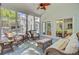 Sunroom filled with lots of natural light, wicker furniture, and a ceiling fan at 4227 Sawgrass Dr, North Charleston, SC 29420