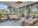 Sunroom filled with lots of natural light, wicker furniture, and a ceiling fan at 4227 Sawgrass Dr, North Charleston, SC 29420