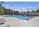 Outdoor swimming pool with diving blocks and lounge chairs surrounded by trees and flags at 4227 Sawgrass Dr, North Charleston, SC 29420
