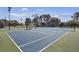 Well-maintained community tennis court under bright lights for evening matches at 4227 Sawgrass Dr, North Charleston, SC 29420