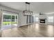 Bright living room with a fireplace, modern chandelier, and sliding glass doors to the patio at 4308 Cotton Flt Rd, Summerville, SC 29485