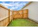 A wooden fence encloses the yard with a gate leading into the backyard, all on a well-maintained lawn at 513 Donnas View Way, Summerville, SC 29486