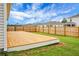 A spacious wooden deck is placed in the backyard surrounded by a well-manicured lawn and a sturdy wooden fence at 513 Donnas View Way, Summerville, SC 29486