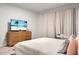 The relaxing bedroom offers a comfy bed, modern dresser, and beach-themed TV for entertainment at 513 Donnas View Way, Summerville, SC 29486