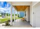 Covered front porch with comfortable seating, wood plank ceiling, and views of the landscaped front yard and street at 513 Donnas View Way, Summerville, SC 29486