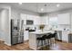 Modern kitchen features stainless steel appliances, island with bar stools, and pendant lighting at 513 Donnas View Way, Summerville, SC 29486