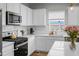 This bright kitchen is equipped with stainless steel appliances and a modern backsplash at 513 Donnas View Way, Summerville, SC 29486
