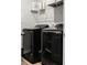 Convenient laundry room boasts a modern washer and dryer, plus ample storage shelving for supplies at 513 Donnas View Way, Summerville, SC 29486