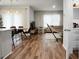Open-concept living and dining area features stylish furniture and wood flooring at 513 Donnas View Way, Summerville, SC 29486