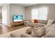 Bright living room with comfortable sectional sofa, entertainment center, and lots of light at 513 Donnas View Way, Summerville, SC 29486