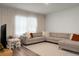 Comfortable living room with a large sectional sofa, bright natural light, and modern decor at 513 Donnas View Way, Summerville, SC 29486