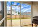 Inviting screened porch features an open doorway to an outdoor deck and beautiful backyard views at 513 Donnas View Way, Summerville, SC 29486